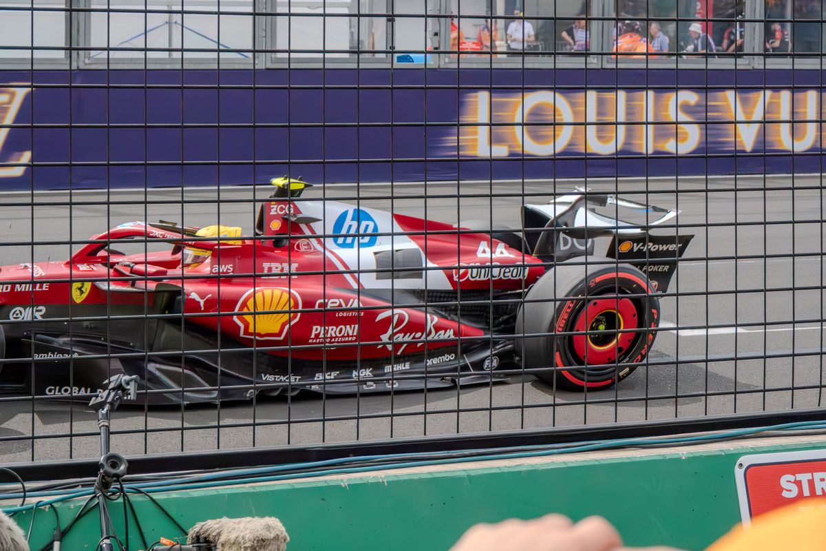 Ferrari number 44 Formula 1 car at speed behind the catch fence at Albert Park, Australian Grand Prix