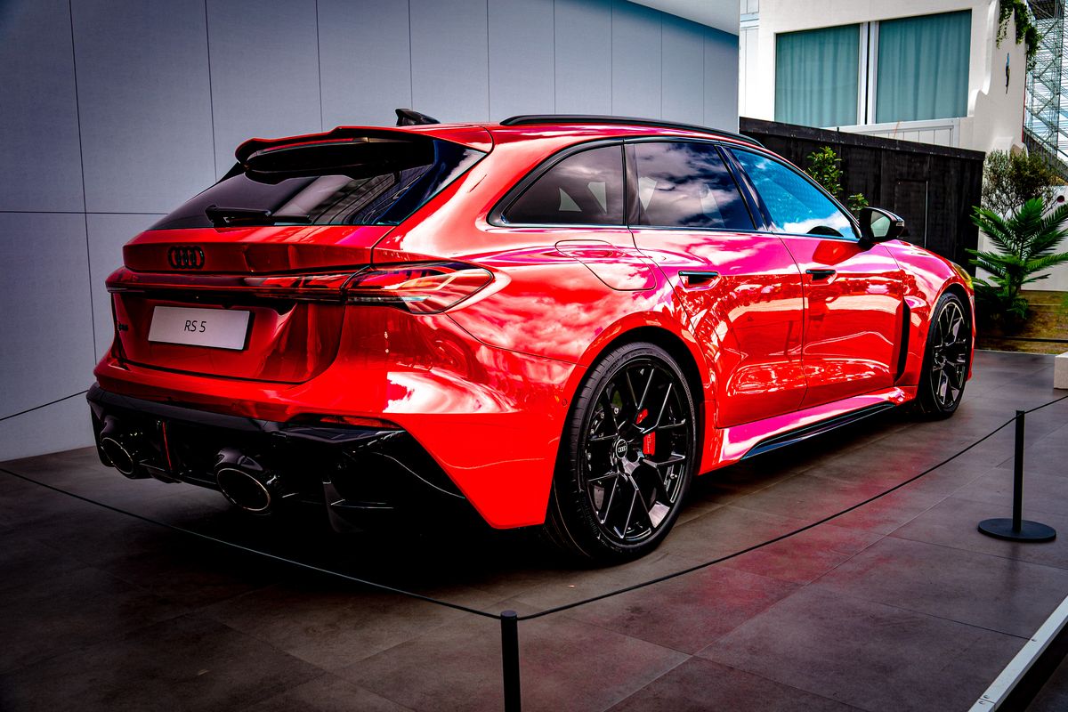 Red Audi RS 5 Avant rear three-quarter view with oval exhausts