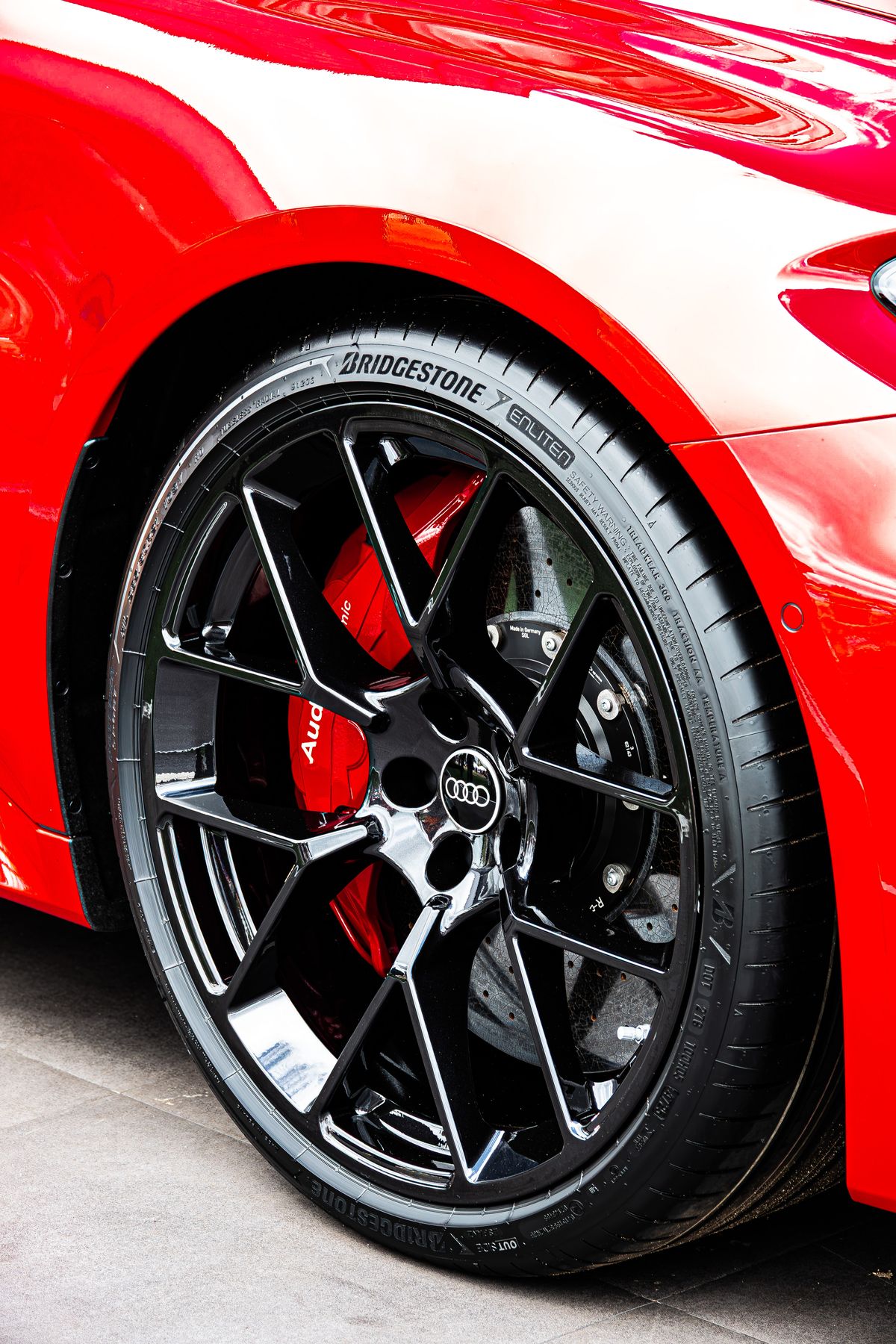 Audi RS 5 black alloy wheel with red Audi ceramic brake caliper and Bridgestone tyre