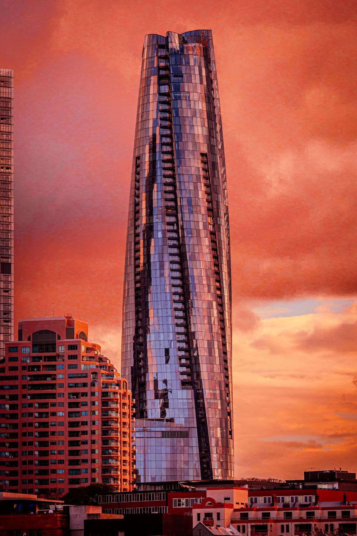 Crown Sydney tower at Barangaroo against a burnt orange sunset sky