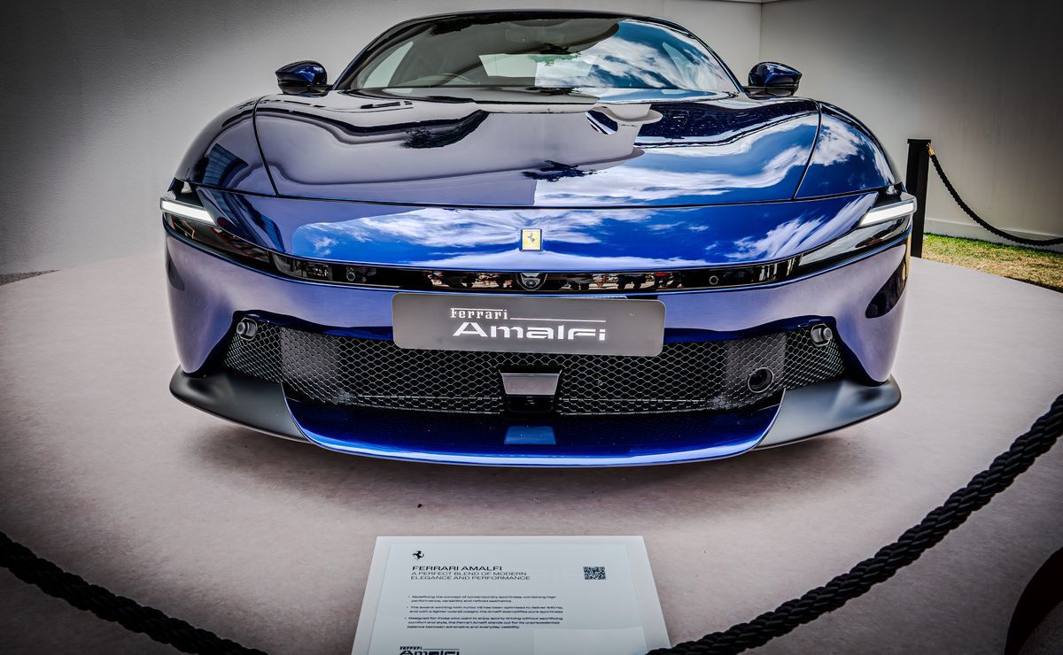 Blue Ferrari Amalfi, nose-on on its display stand behind a rope barrier
