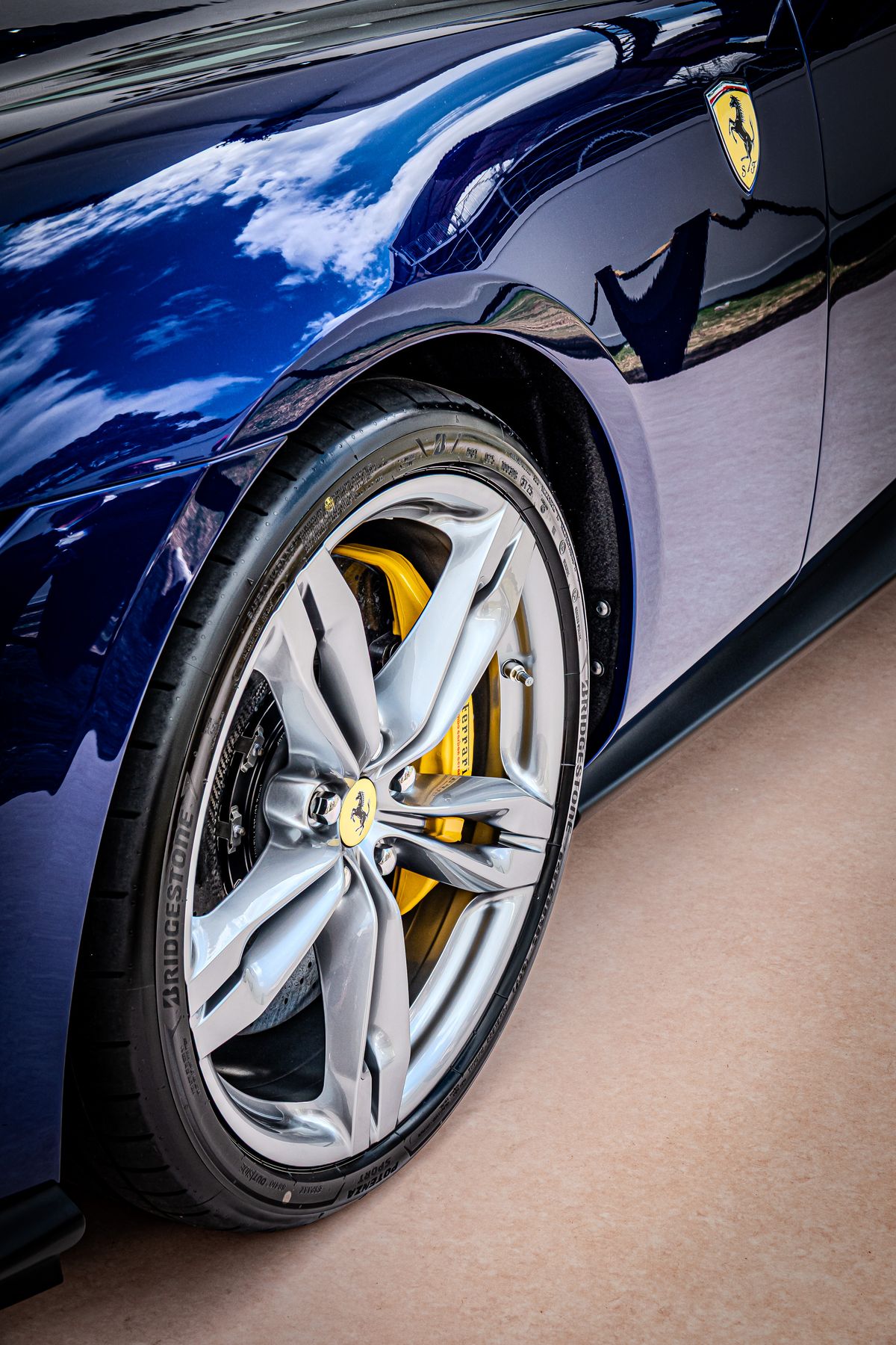 Ferrari Amalfi front wheel, yellow Ferrari brake caliper and prancing horse shield on the fender