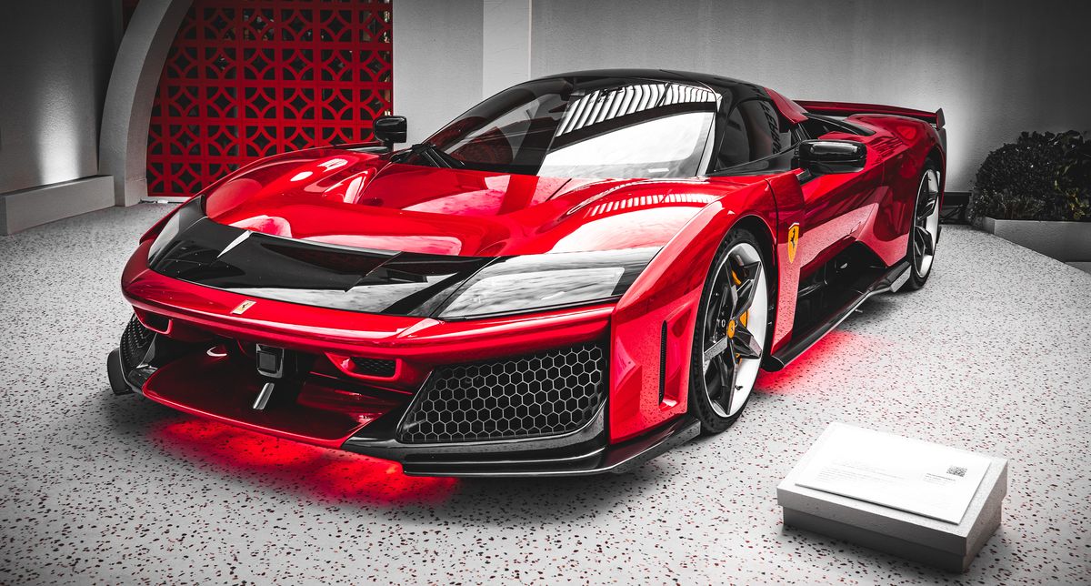 Red and black Ferrari F80 hypercar on display under red floor lighting at the Australian Grand Prix