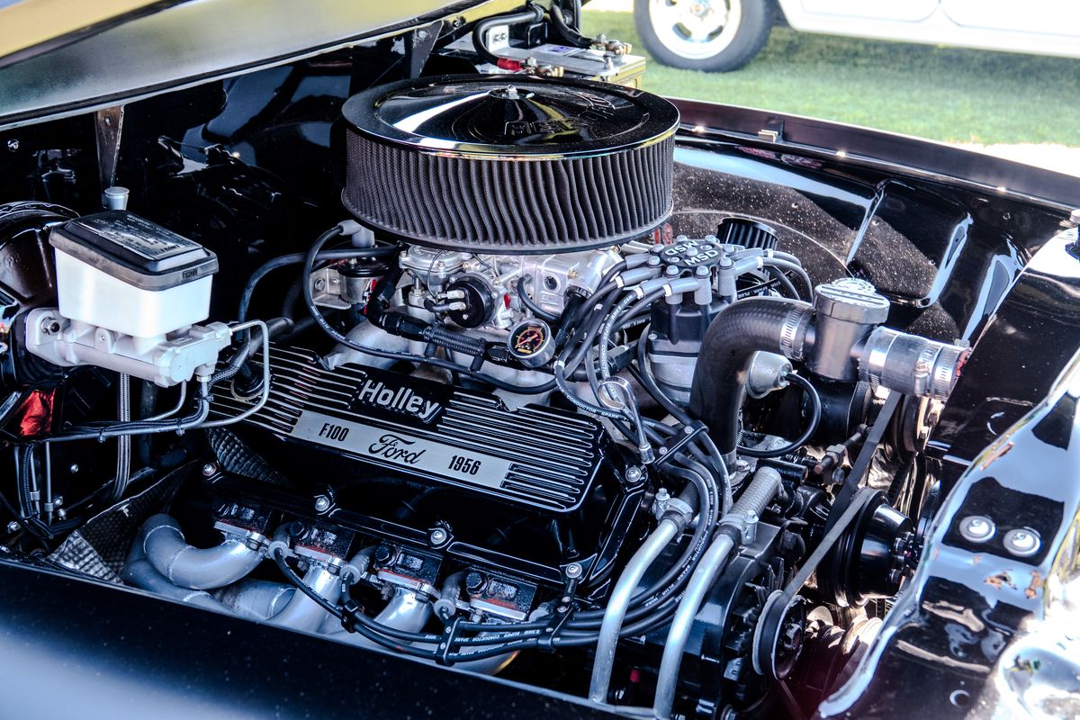Restored 1956 Ford F100 engine bay with Holley valve covers and chrome air cleaner