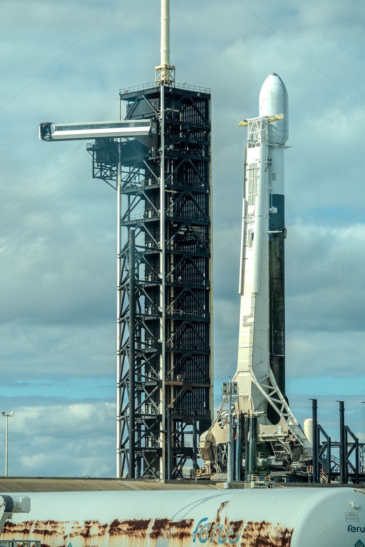 SpaceX Falcon 9 rocket on the launch pad beside its service tower, Florida