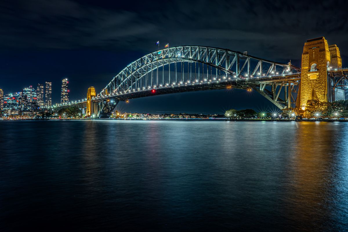Sydney Harbour Bridge at night reflected in still water, 30-second long exposure