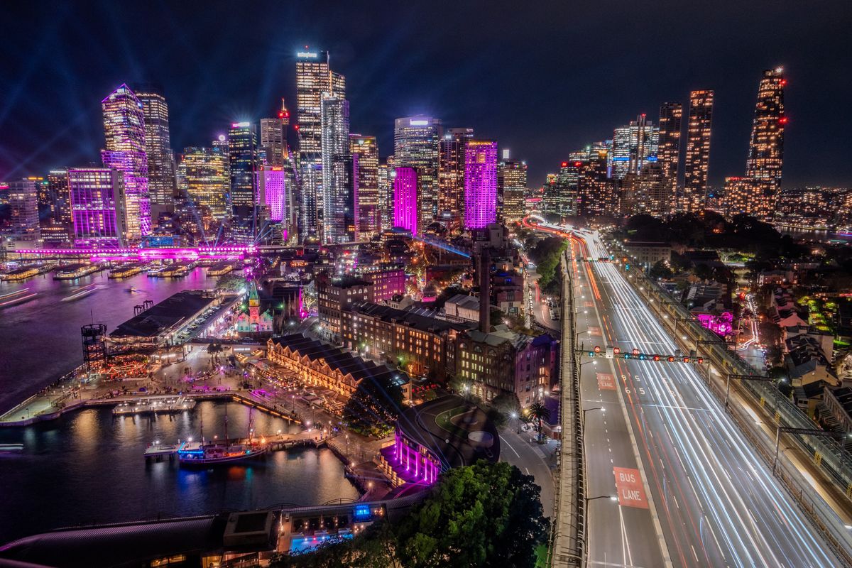 Circular Quay and the Sydney skyline during Vivid Sydney with traffic light trails on the Cahill Expressway