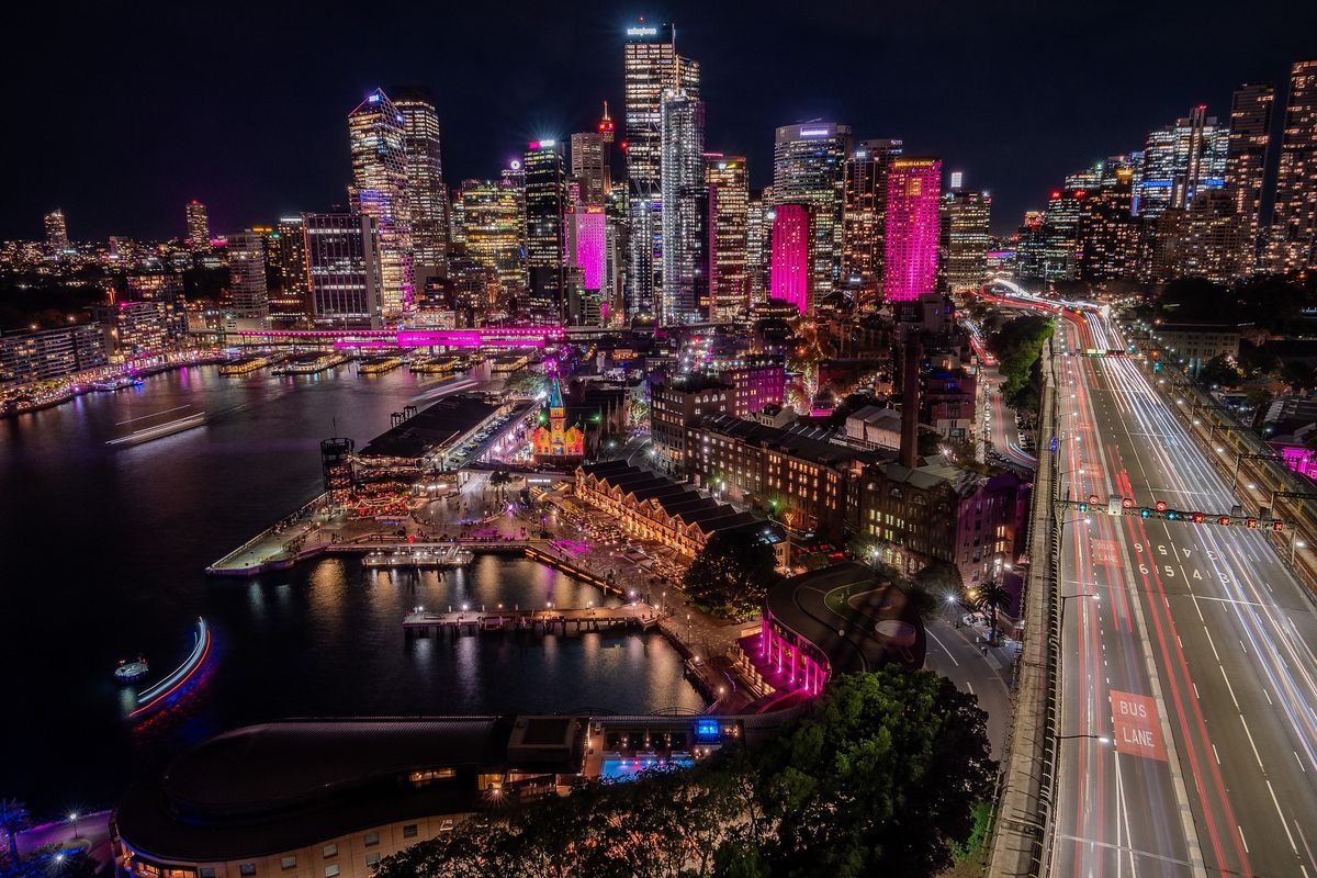 Circular Quay and The Rocks from above during Vivid Sydney, with traffic light trails