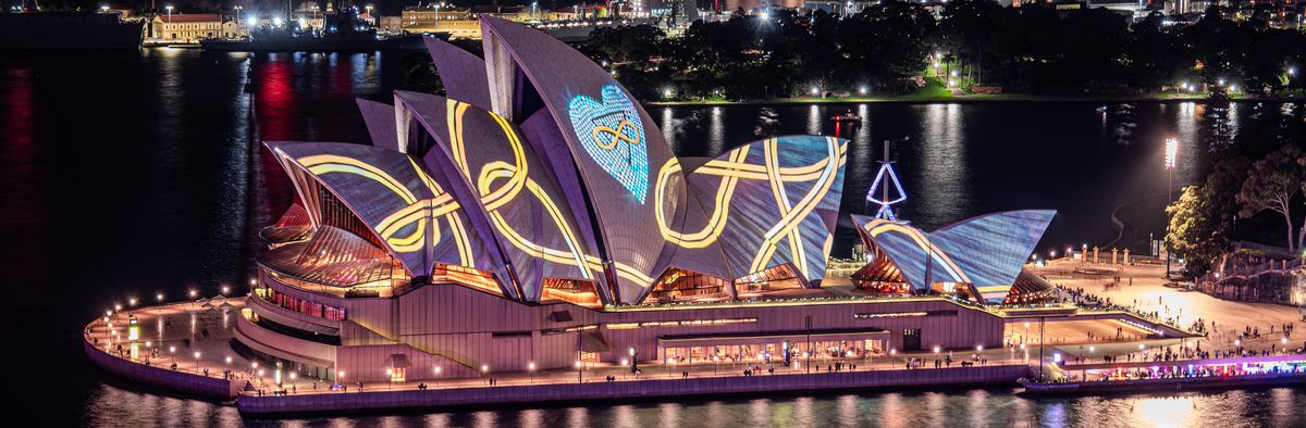 Panorama of the Sydney Opera House sails lit with Vivid Sydney projections at night